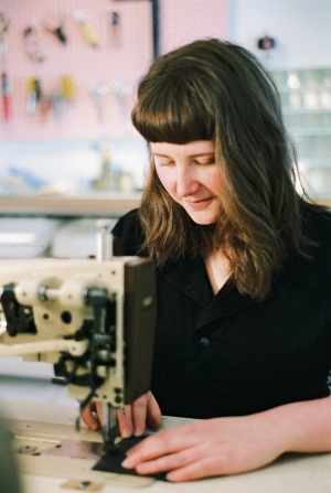 Tess Gobeil works at a sewing machine