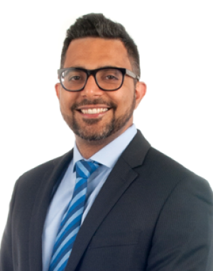 Headshot of Sain Godil, wearing suit and tie