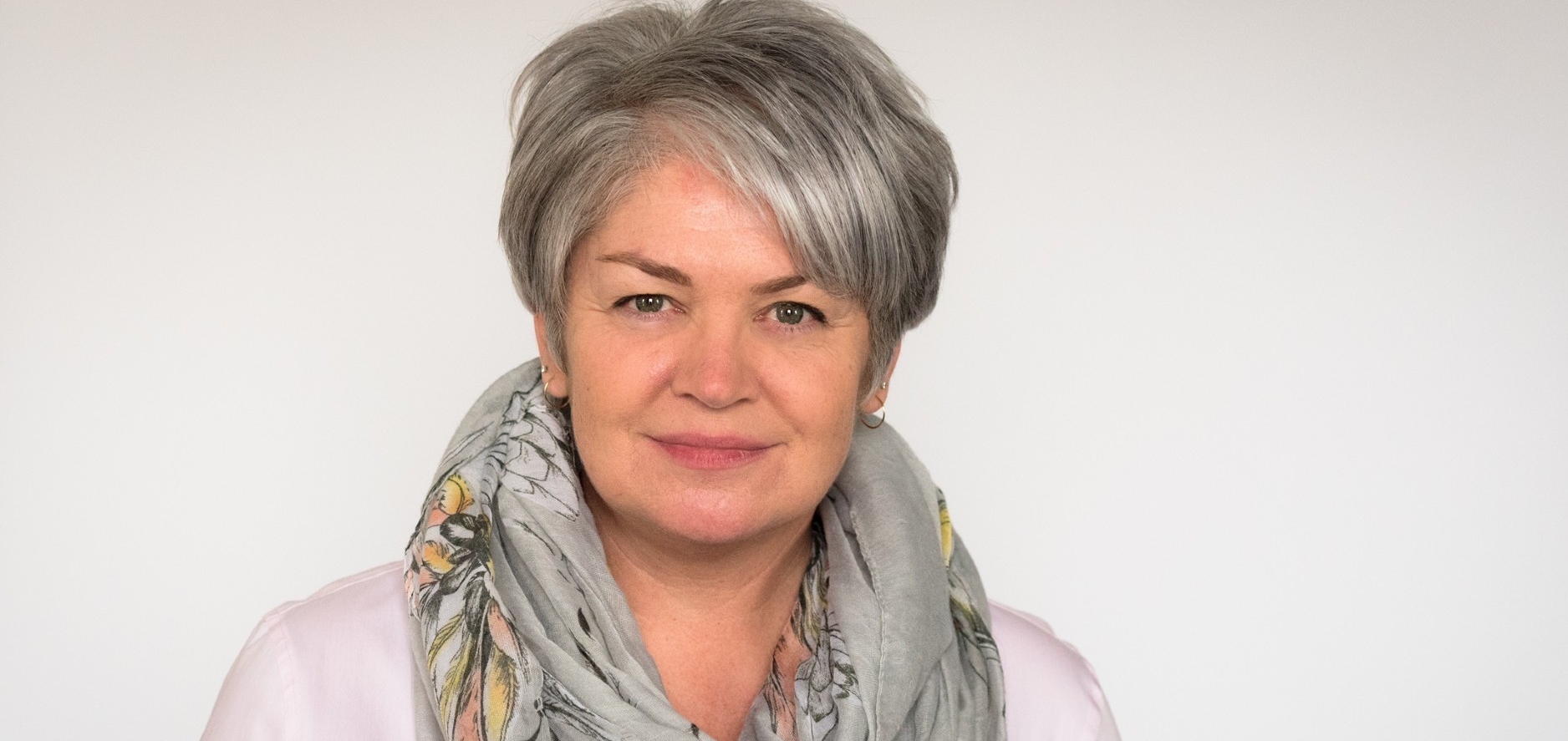 headshot of Sherry Romanado, wearing a sweater and scarf