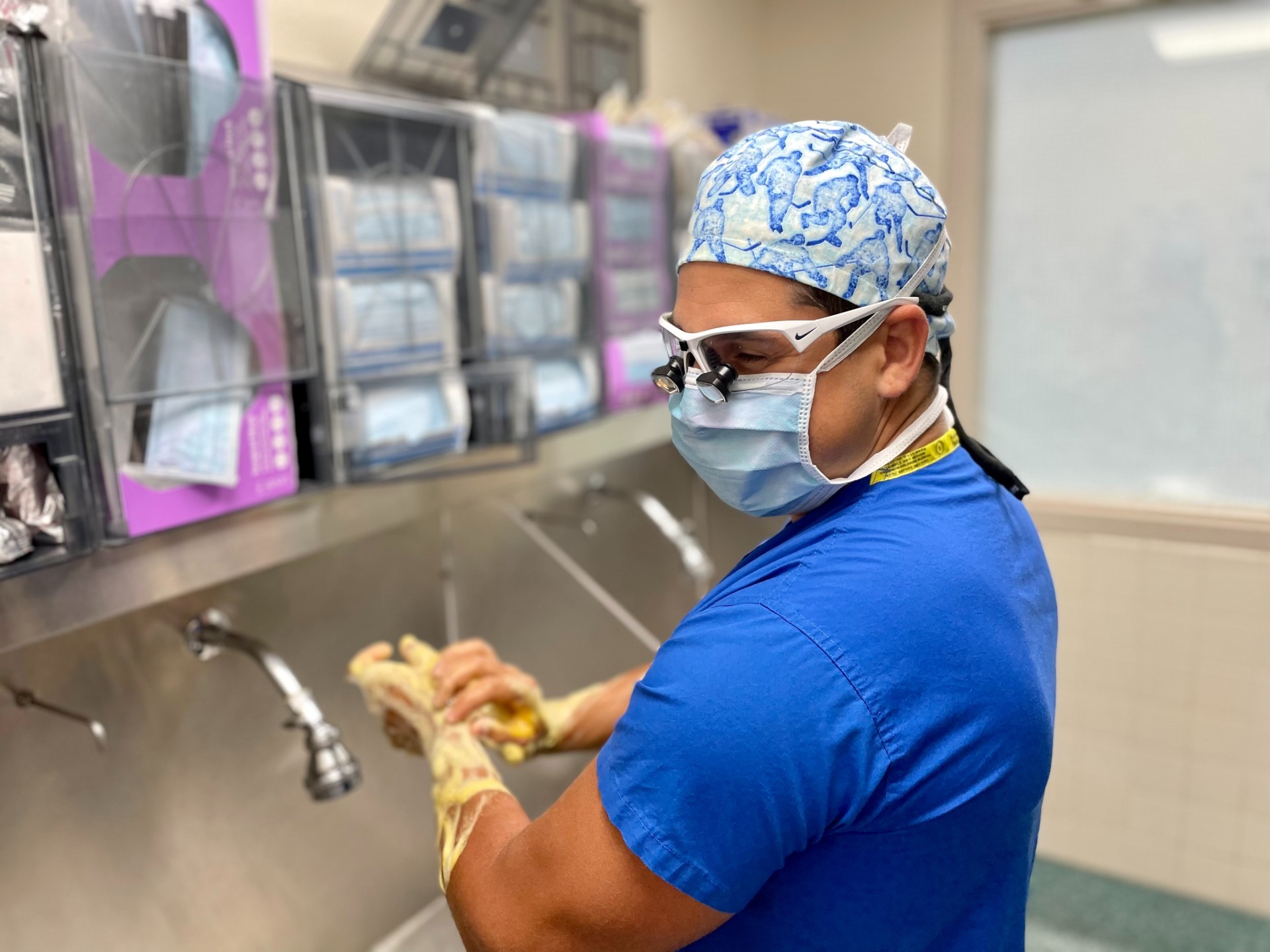 Medical resident Matthew Carnevale washes his hands