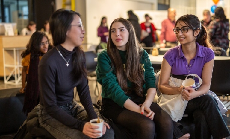 Three students sit and talk in 4TH SPACE on the Sir George Williams Campus.