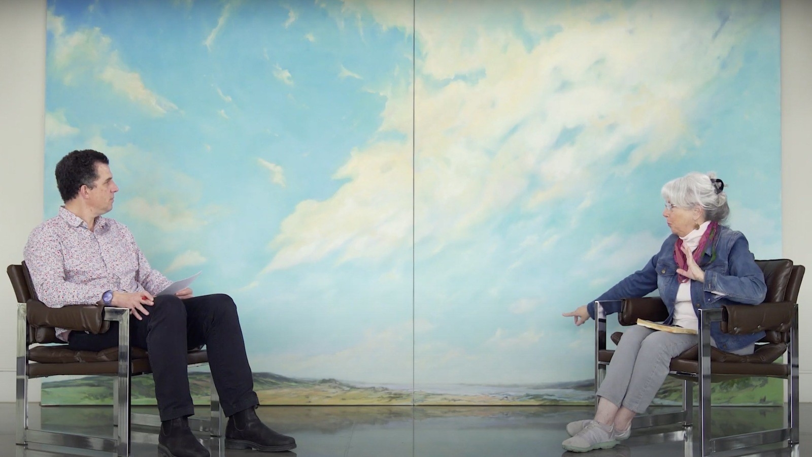 a video still of John Leroux interviewing an artist