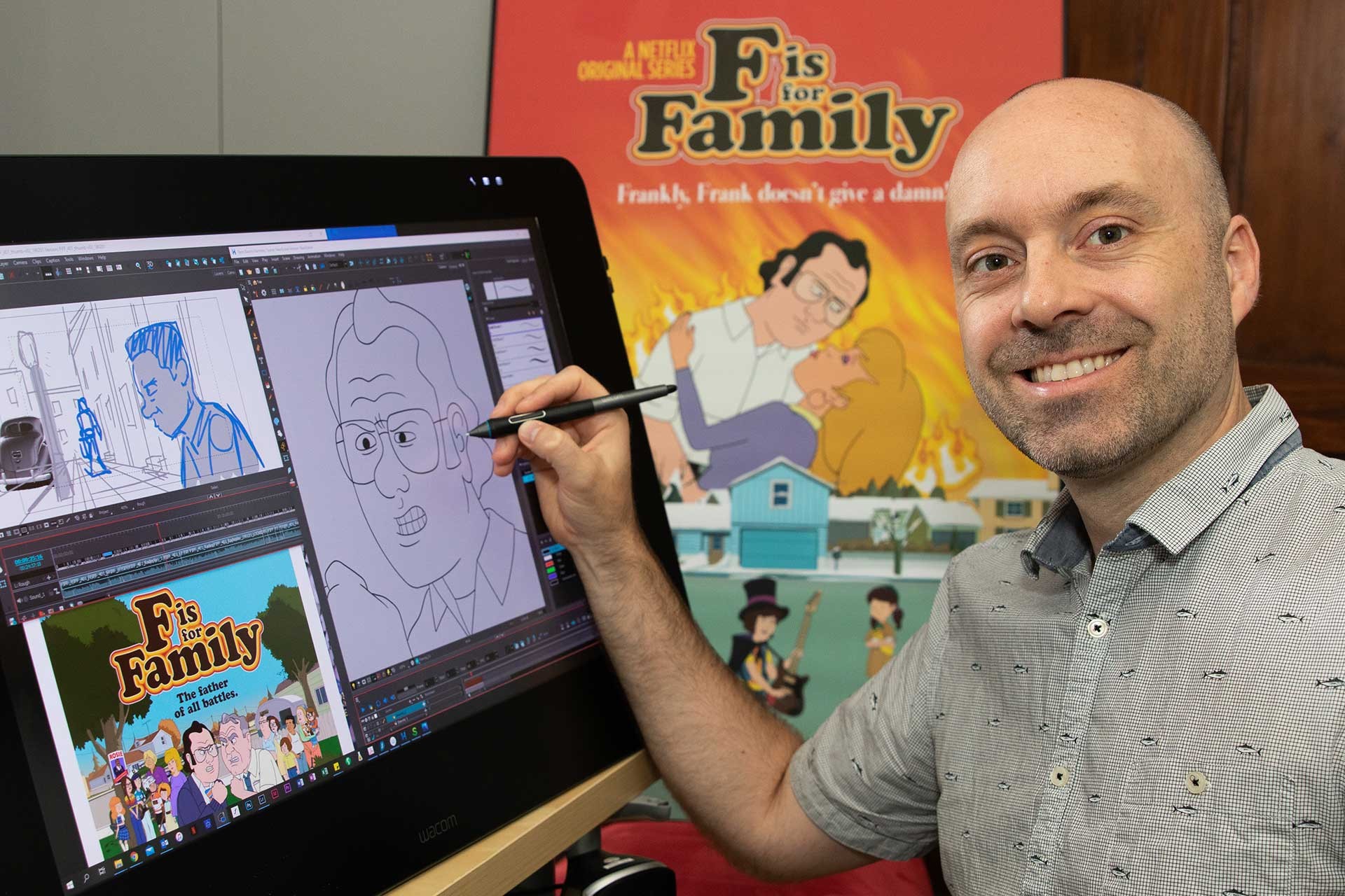 A smiling man poses in front of computer with animated sketches