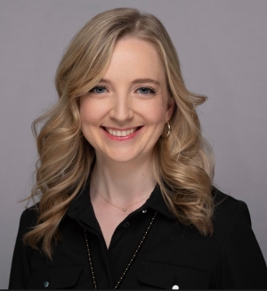 Headshot of woman with blonde hair and black shirt smiling