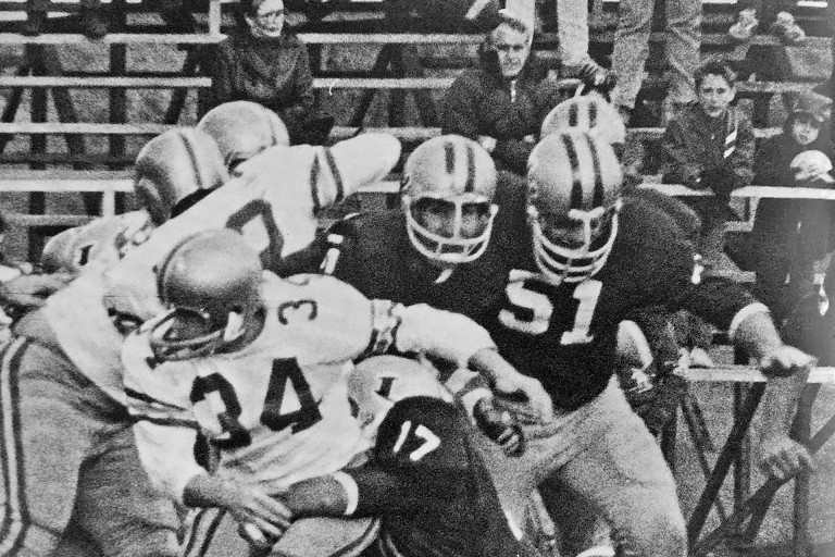 A black-and-white image of the Loyola College football team playing an opponent.