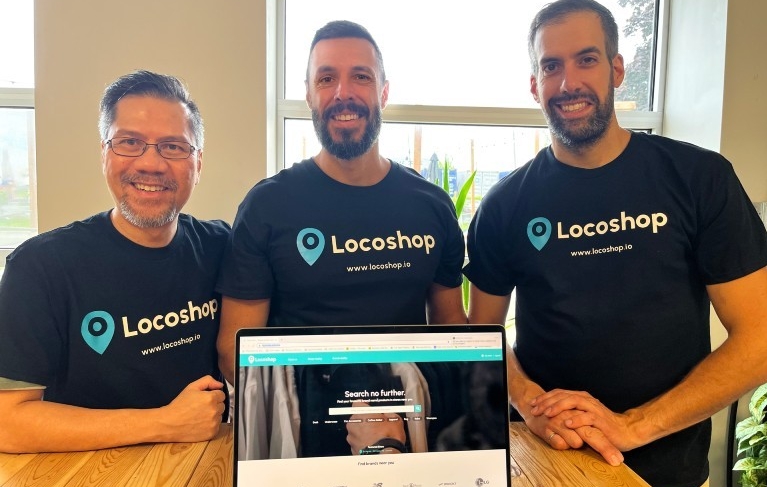 Minh-Dien Le, Dan Facciolo and Alexandre Santos Three men wearing matching Locoshop T-shirts stand in front of an open laptop
