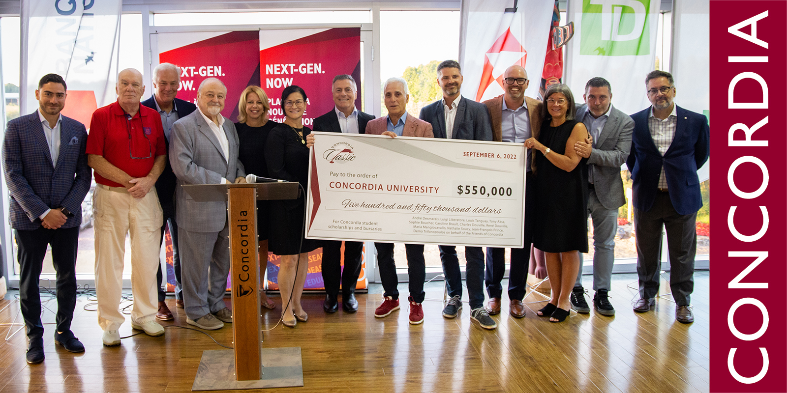 Group photo of men and women holding a cheque