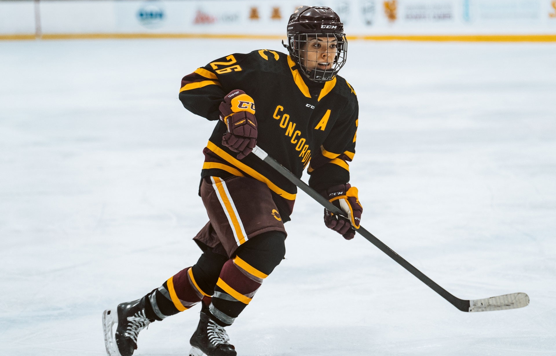 A hockey player for the Concordia Stingers skates along the ice