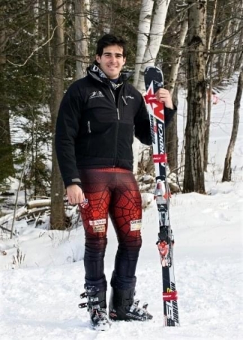 Outside on a snowy winter day, Alex Leopold holds his skis