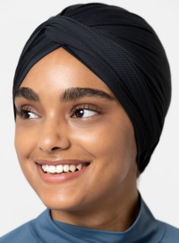 Close up of woman wearing a black sports turban and blue shirt