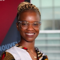 Fatoumata Camara is smiling and wears glasses with clear frames. Her hair is black with blonde braids tied back behind her head.