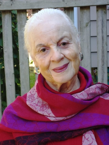 Portrait of white-haired woman wearing a colourful scarf