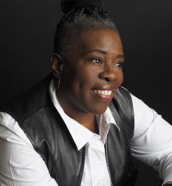 Smiling woman wearing a white blouse and black vest