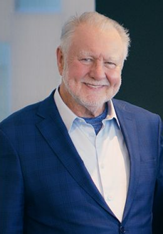 Portrait of a man with white hair and beard, wearing blue suit, no tie