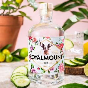 A close-up of the label of a bottle of Royalmount Gin which depicts a rabbit head with deer antlers, surrounded by roses.