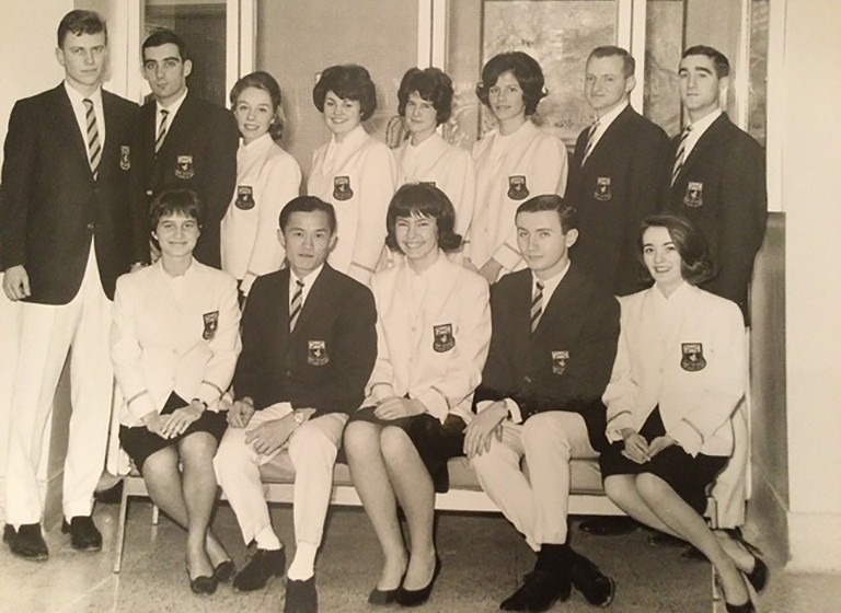 Garnet Key 1962-63 A sepia tone image of a group of students who wear blazers with a crest. The women wear white ones and the men wear dark ones