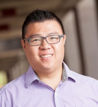 Portrait of a man wearing a button-up shirt and glasses