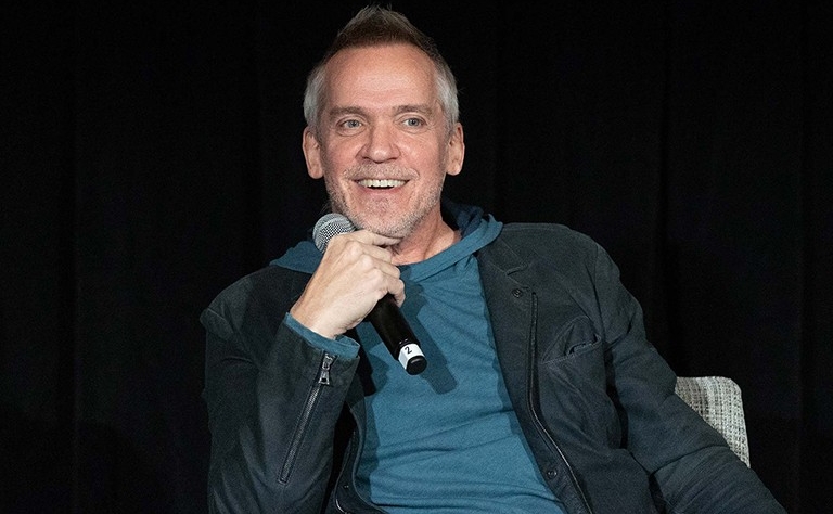 Jean-Marc Vallée The late Jean-Marc Vallée is pictured sitting down, smiling while holding a mic near his face. He is wearing a blue hoodie under a black jacket.