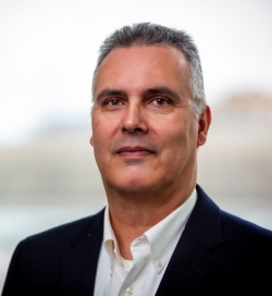 Portrait of a man wearing a black blazer with white-collard shirt