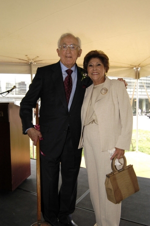 A photo of a husband and wife posing together smiling