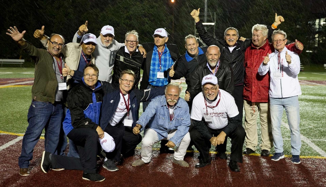 Concordia's 1973 men's soccer team pose for a photo in the rain