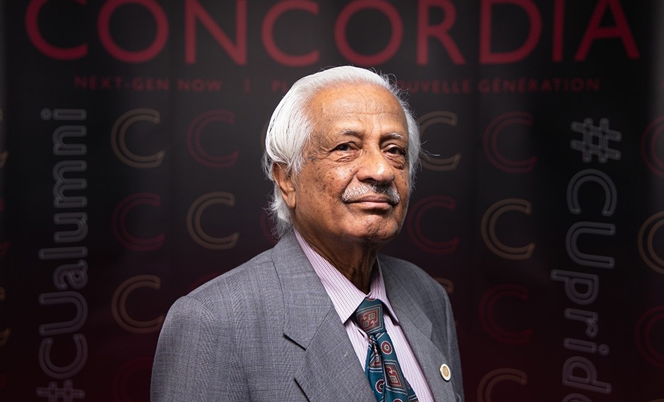 A man in a suit and tie. He smiles at the camera