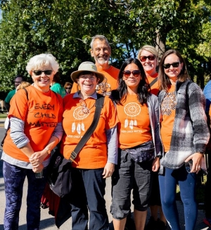 Group of people wearing orange shirts