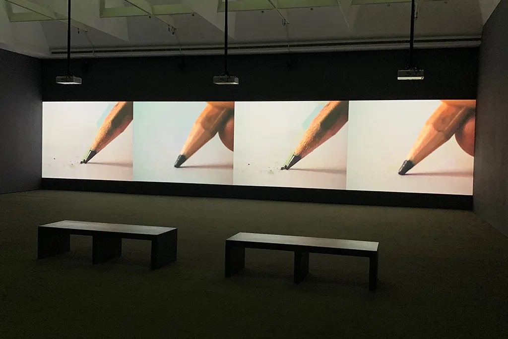 Pencil video art installation across multiple screens.