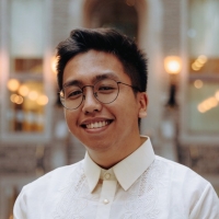 Portrait of a man, smiling, wearing a white button-up shirt