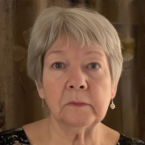 Woman with short hair and earrings looks into the camera