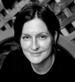 Black and white headshot of a woman with short black hair parted down the middle