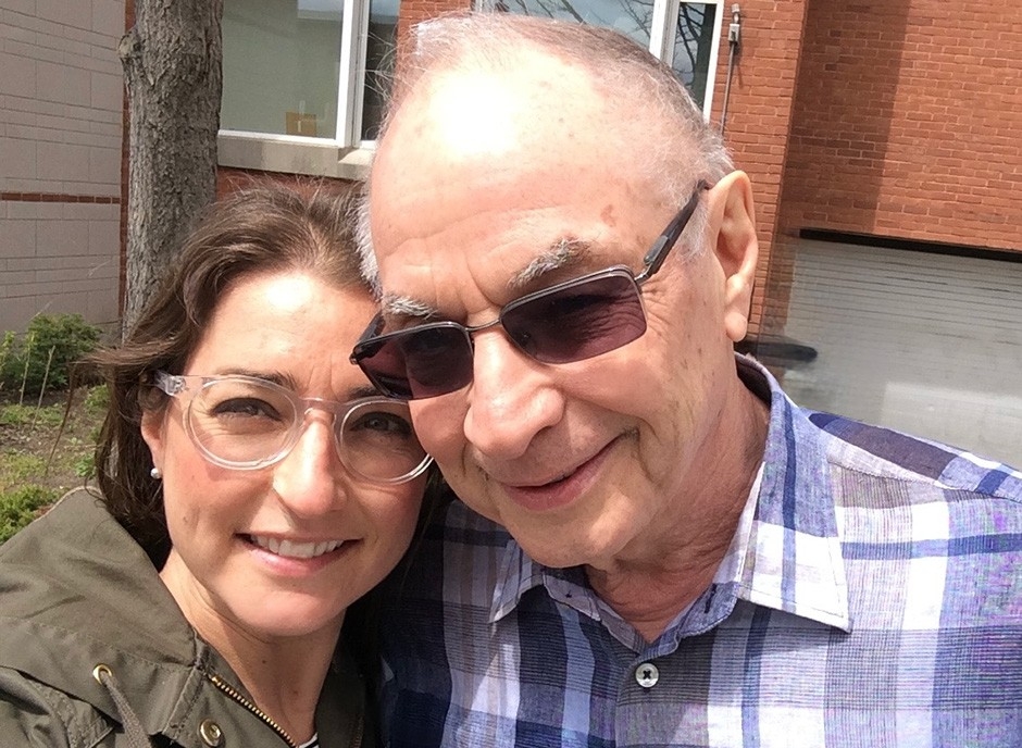 alt="Hannah and her father David Zitnsr pose closely together for a selfie."