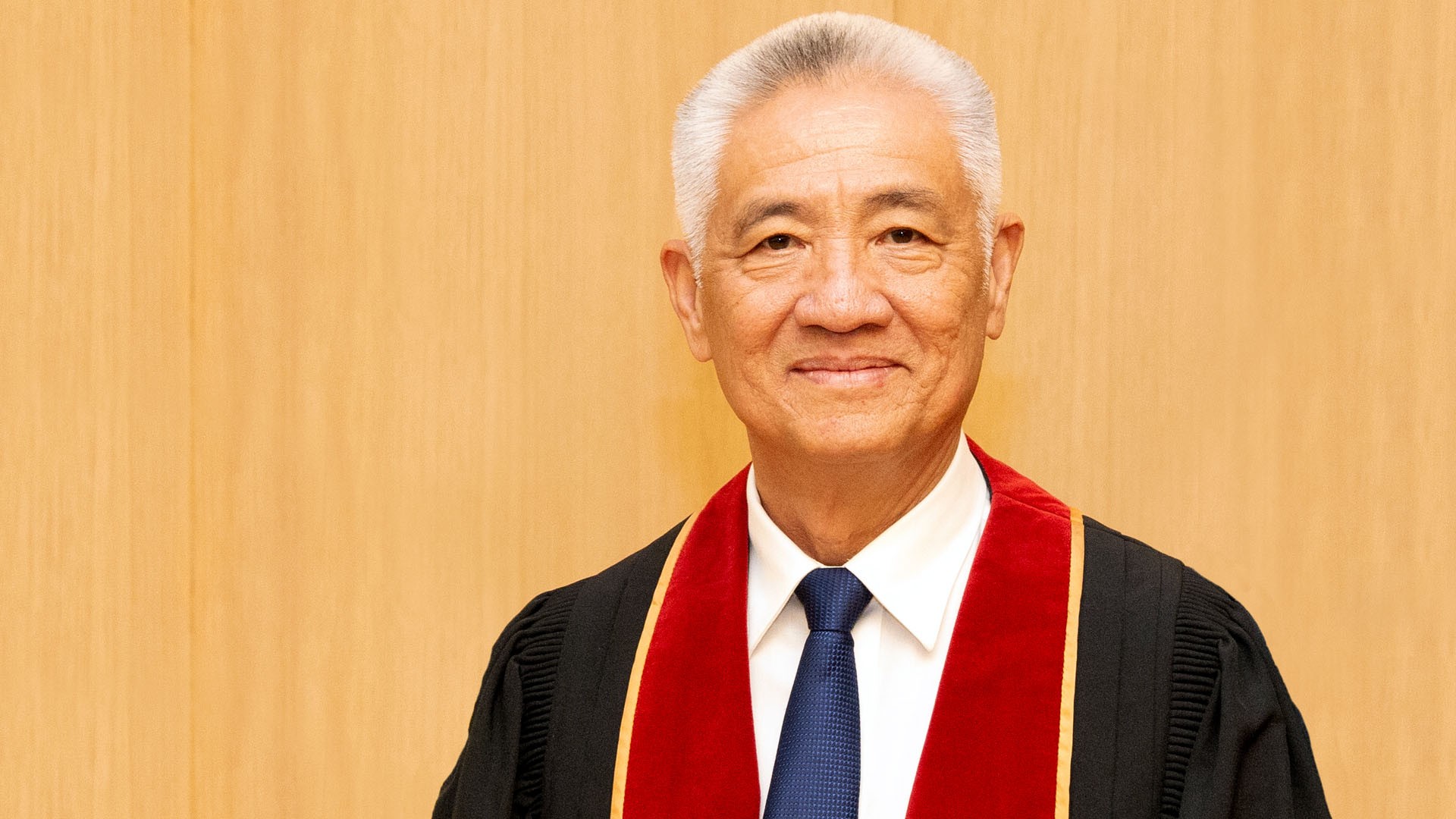 Thanh My Nguyen, BSc 86, MSc 88, LLD 24 Thanh My is wearing academic robes; he has short silver hair and smiles.
