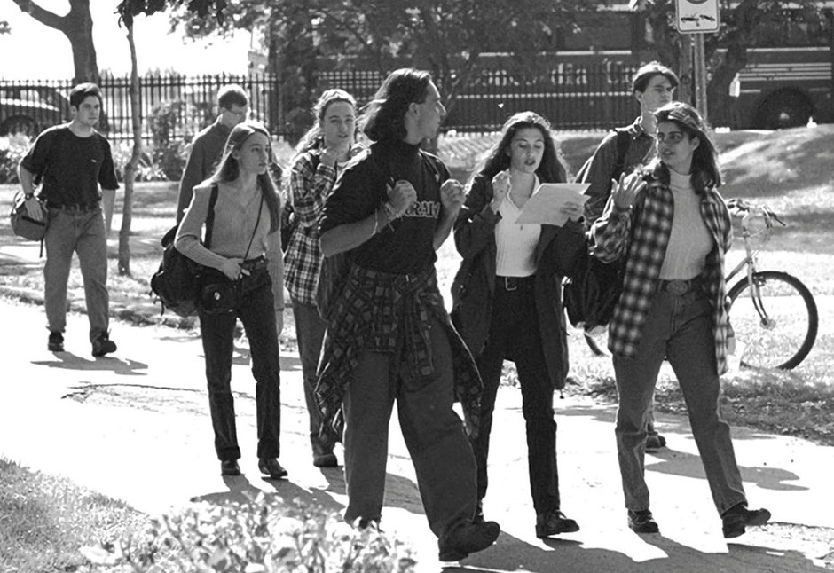 A black and white yearbook photo of students on Loyola Campus wearing jeans and flannel shirts.