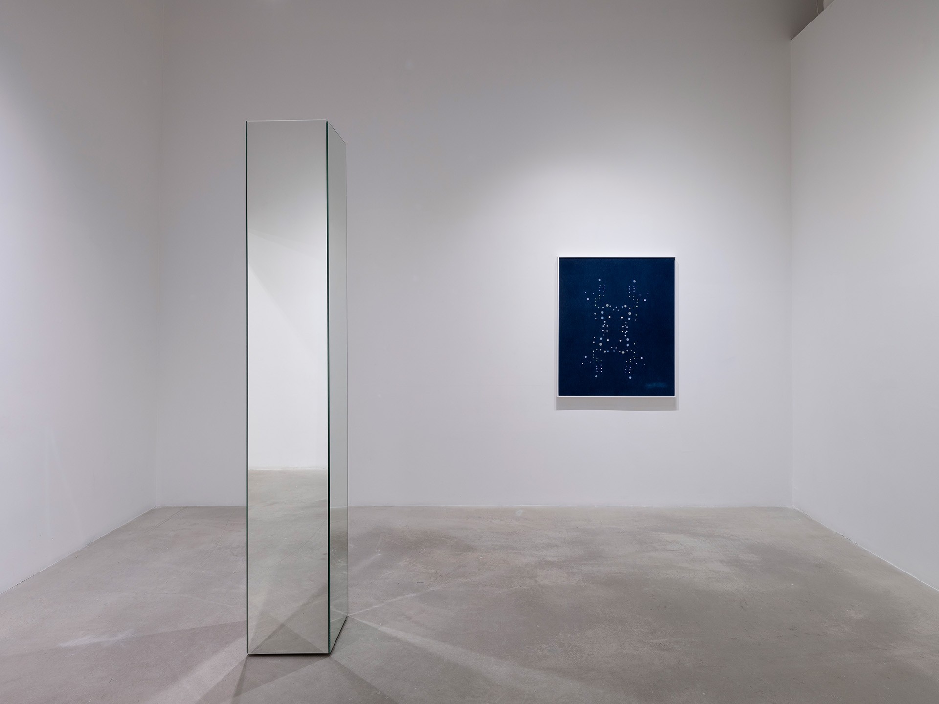 A display of art in a white-walled gallery.