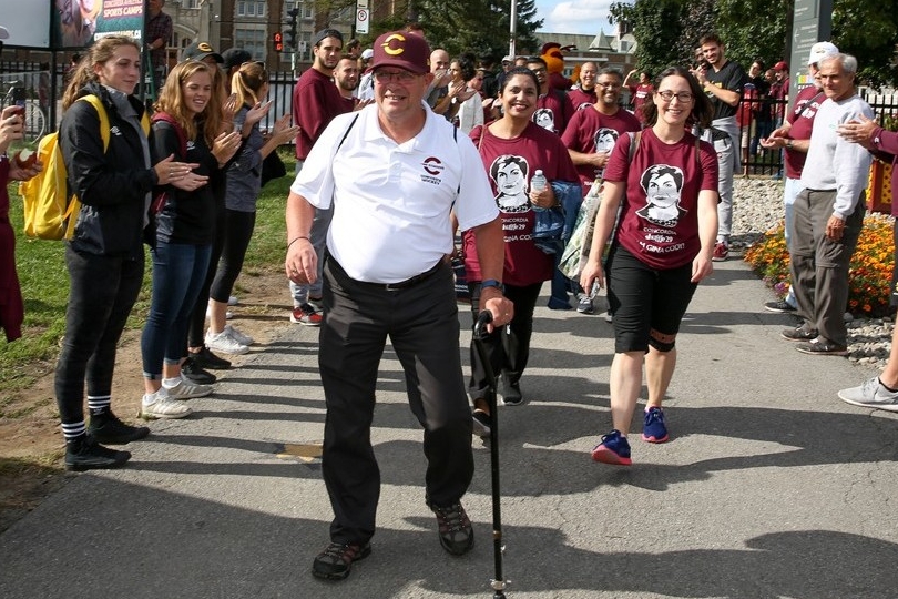 Person walks through cheering crowd.
