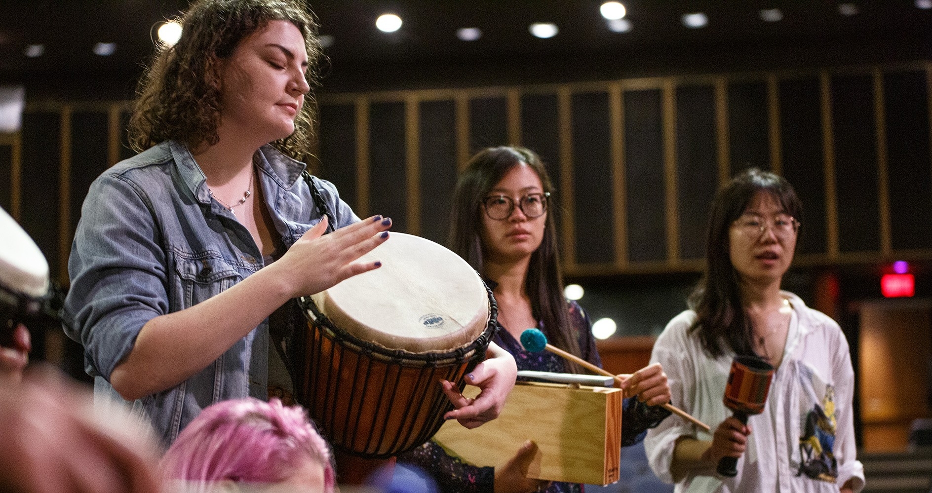 Three women play musical instruments.