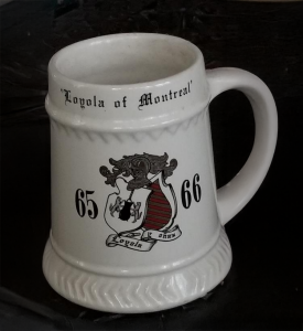 A vintage white Loyola College mug with coat of arms and the years 65-66 on it.