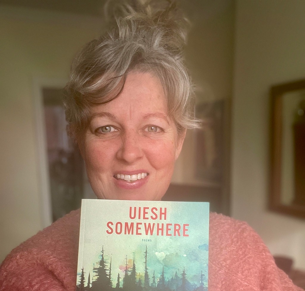 Jessica holds up the book she translated.