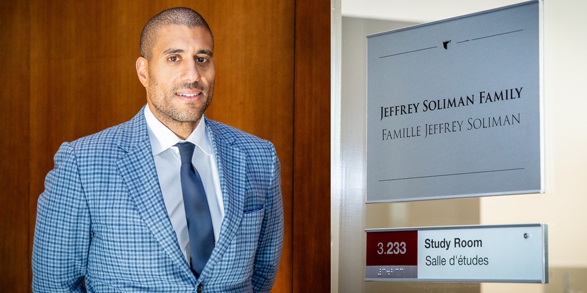 man wearing a checked suit jacket with white shirt and patterned tie, next to a plaque on the study room named in his family's honour. 