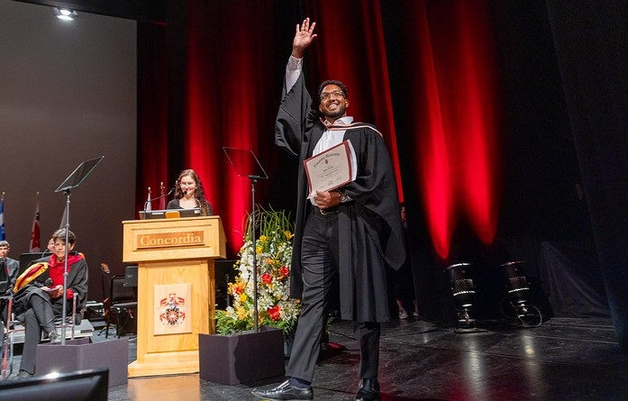 A Concordia graduate proudly crosses the stage at convocation.