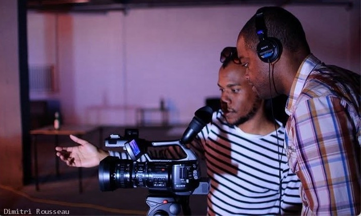 Two people look into a cinema camera