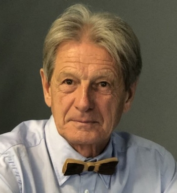 Man wearing button-up shirt with bow tie.