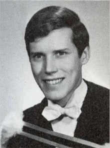 Black and white headshot of L. Ian MacDonald in graduation gown.