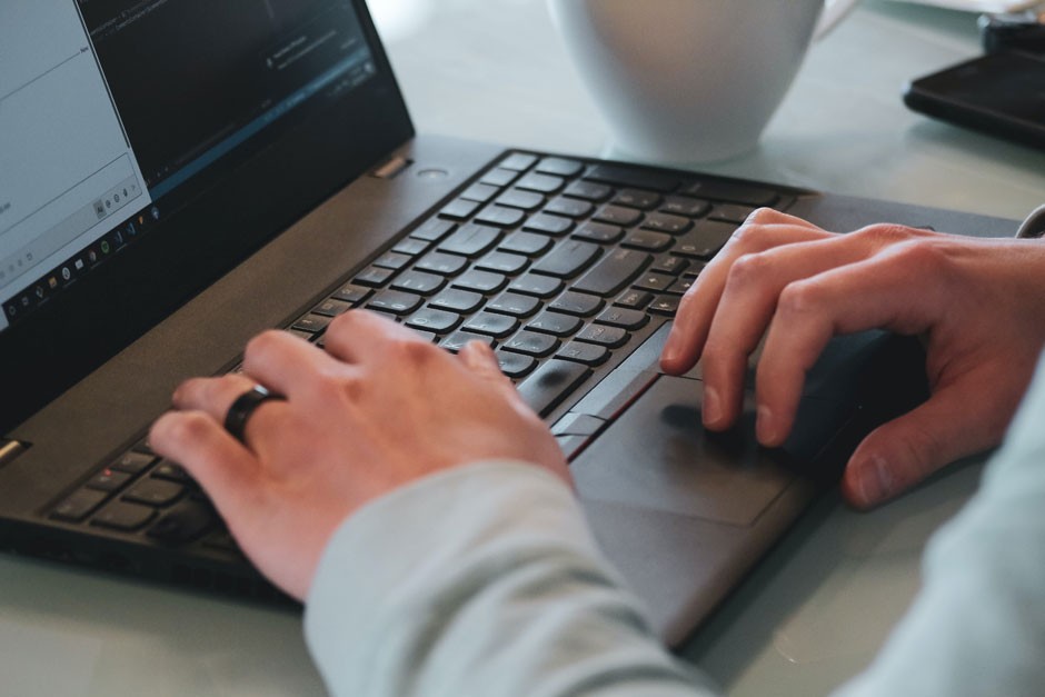 Man's hands typing on laptop