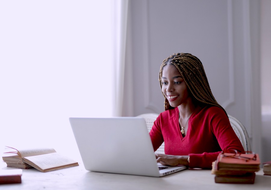 Woman sitting, working on a laptop