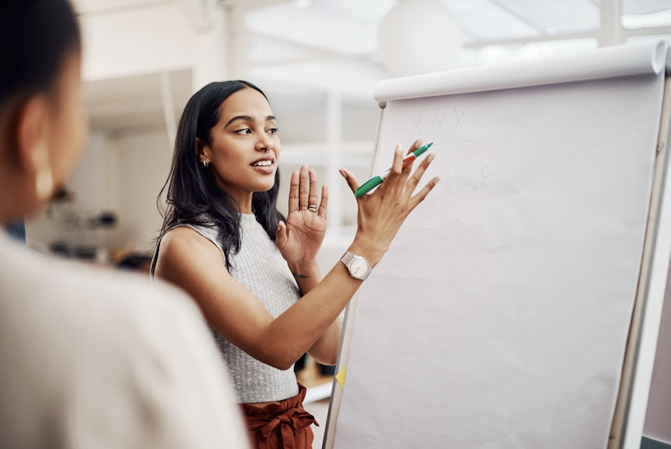 Woman delivers a lesson on a flip chart
