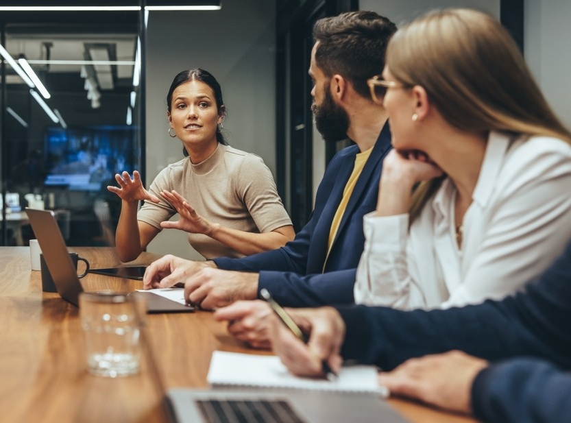 A woman speaks up at a team meeting A woman speaks up at a team meeting