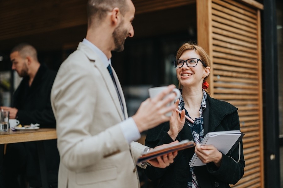 Two colleagues share laughter at work