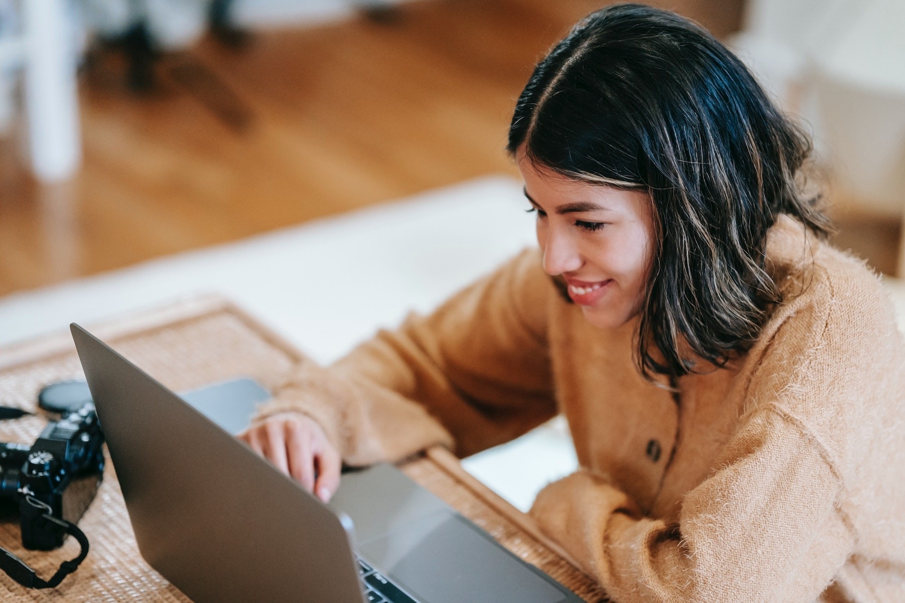 Student smiling, on laptop